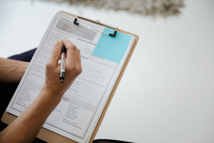 Writing on a form attached to a clipboard