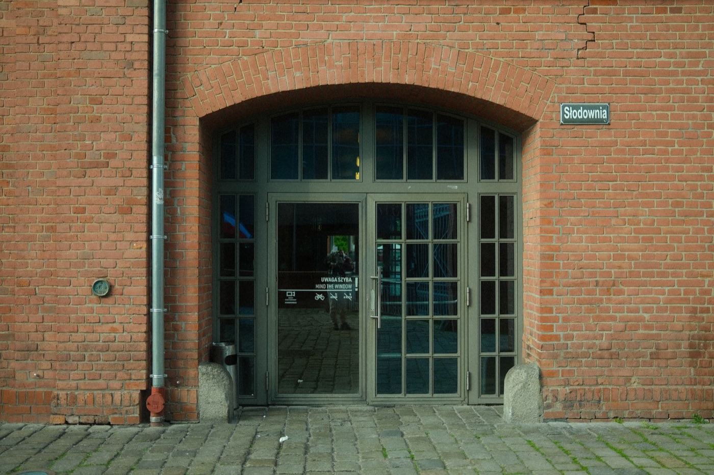 Brick building entrance with a glass-paneled door