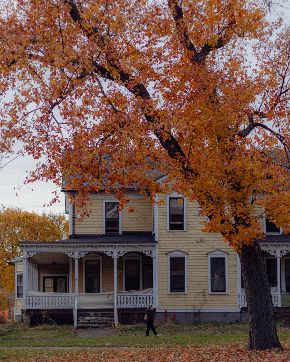 Front porch of a single-family home under autumn trees