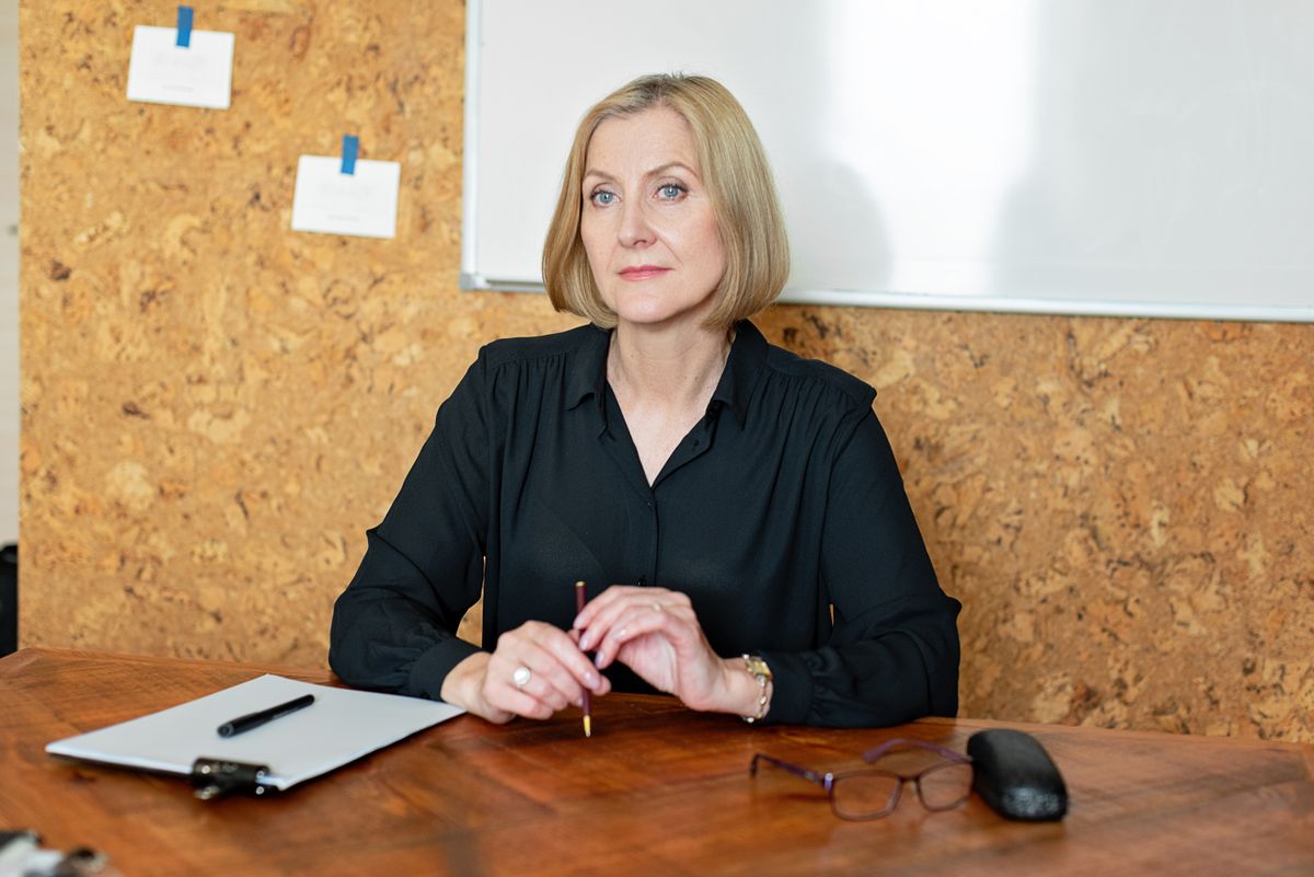 Portrait of the company president seated at her desk