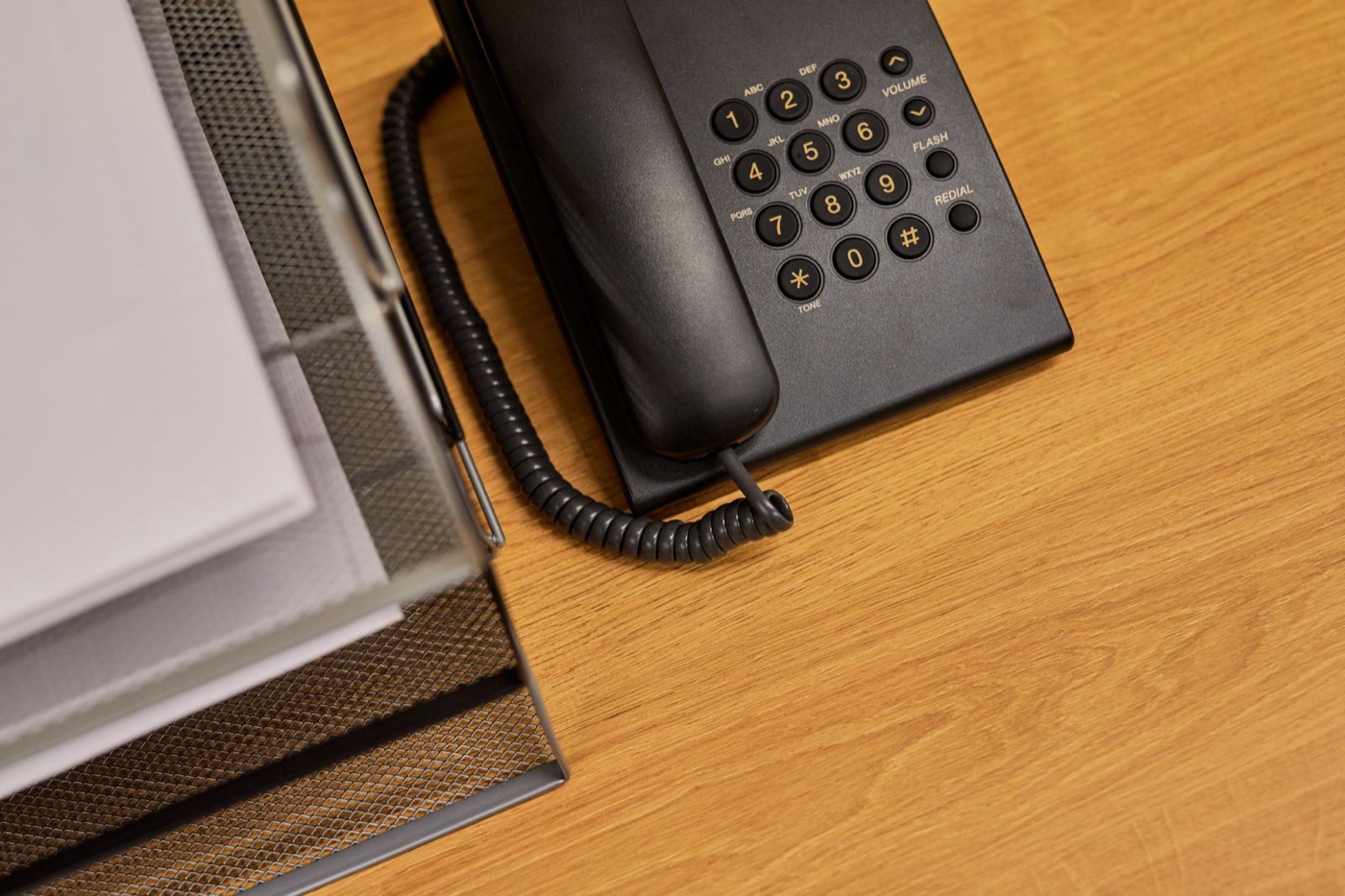 Office desk with a telephone and neatly organized paperwork